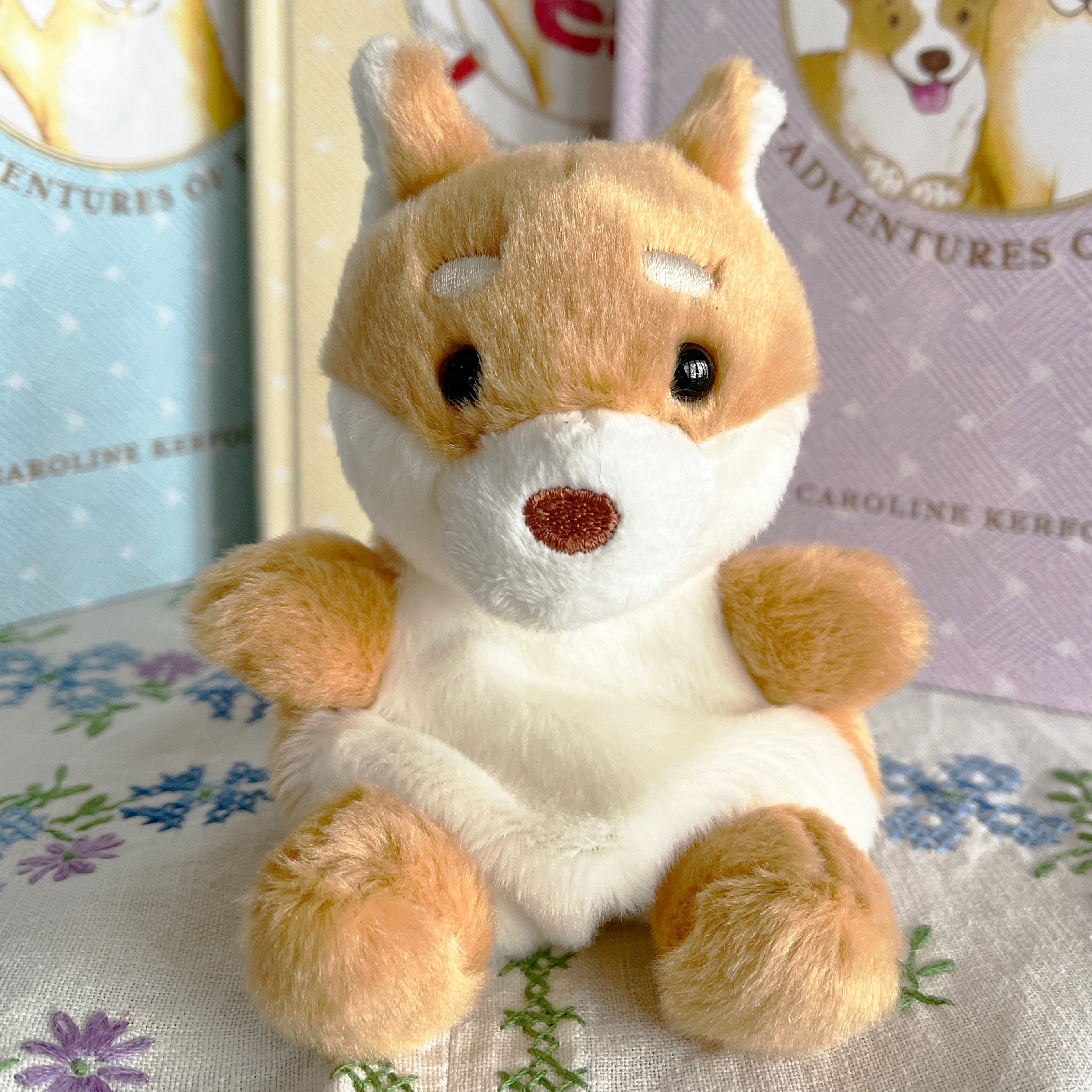 Plush Fox the dog toy on a floral fabric background